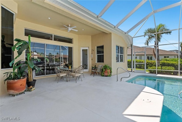 outdoor pool with a patio, a ceiling fan, and a lanai