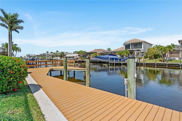 dock area with a residential view and a water view