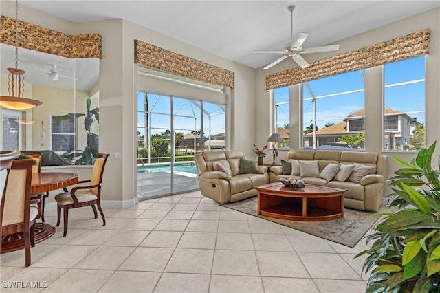 living room with light tile patterned flooring, ceiling fan, and a sunroom