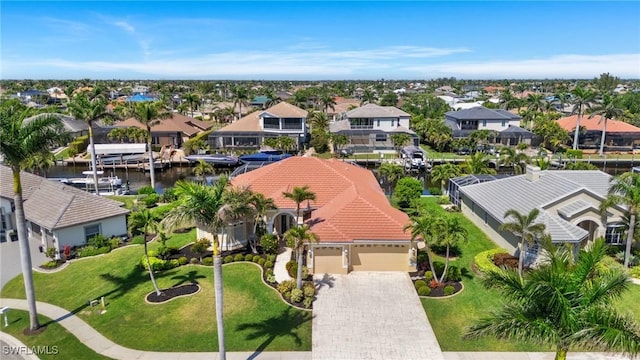 drone / aerial view featuring a residential view and a water view