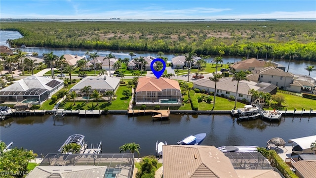 bird's eye view with a residential view, a view of trees, and a water view