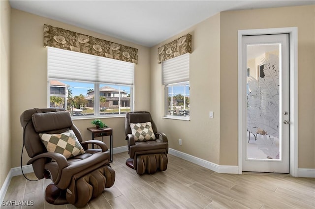 living area featuring baseboards and wood finished floors