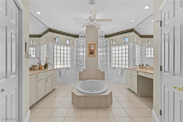 bathroom with plenty of natural light, ceiling fan, tile patterned flooring, and a bath