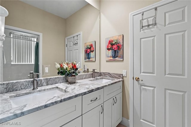 bathroom featuring a sink and double vanity