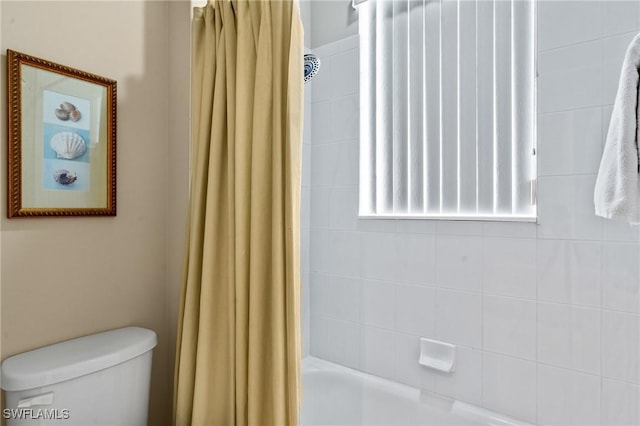 bathroom with toilet and shower / bath combo