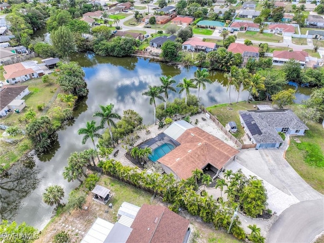 drone / aerial view featuring a residential view and a water view