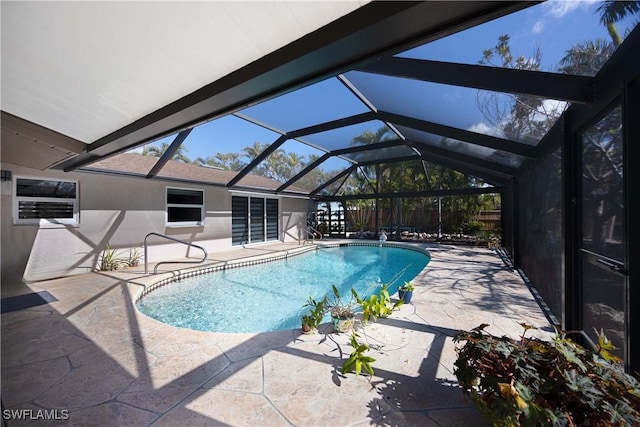 pool with a patio area and a lanai