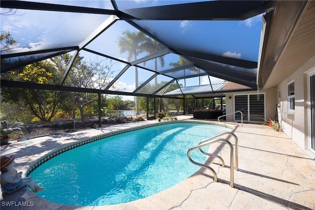 outdoor pool featuring a lanai, a patio area, and a water view