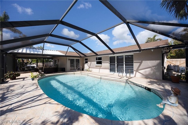 outdoor pool featuring a patio area, fence, and a lanai