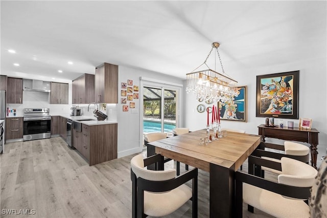 dining area with baseboards, light wood-type flooring, and recessed lighting