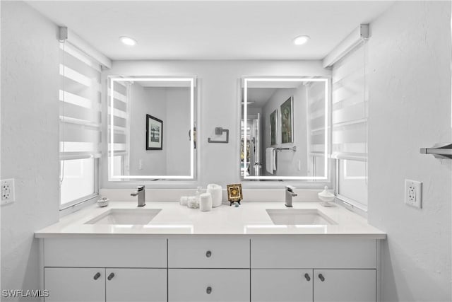 bathroom featuring double vanity and a sink