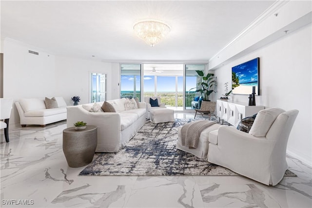 living room with marble finish floor, visible vents, ornamental molding, a wall of windows, and a chandelier