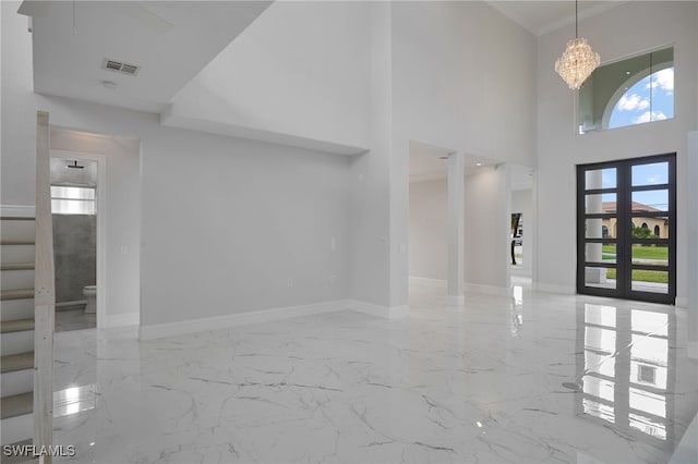 foyer entrance with visible vents, baseboards, plenty of natural light, and marble finish floor