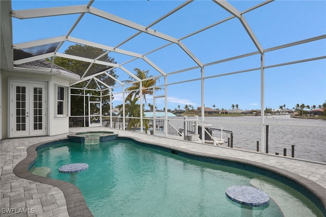 view of pool featuring a patio, french doors, a pool with connected hot tub, and a lanai