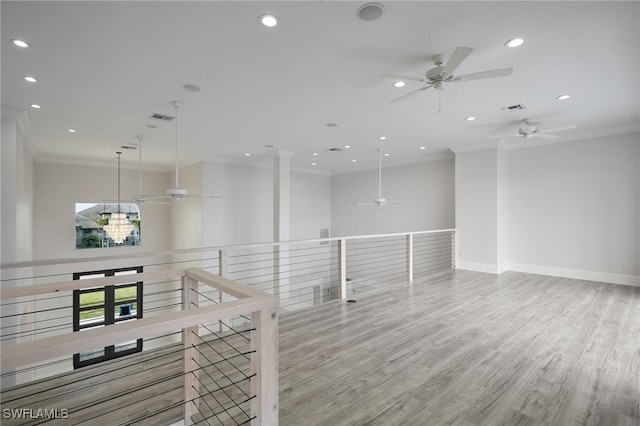 unfurnished room featuring crown molding, recessed lighting, visible vents, and light wood finished floors