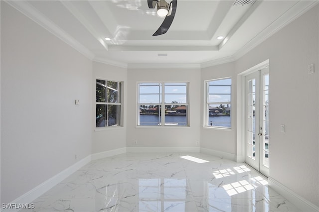 empty room featuring a tray ceiling, french doors, marble finish floor, and baseboards