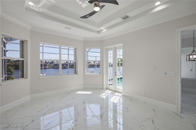 unfurnished room featuring a tray ceiling, baseboards, marble finish floor, and french doors