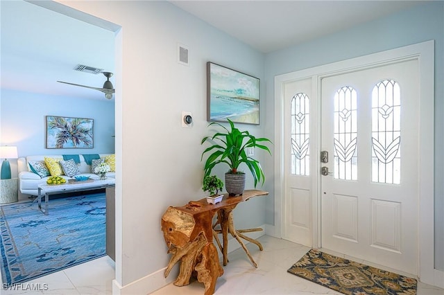 foyer entrance with marble finish floor and visible vents