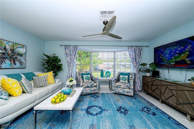 living area featuring visible vents and a ceiling fan