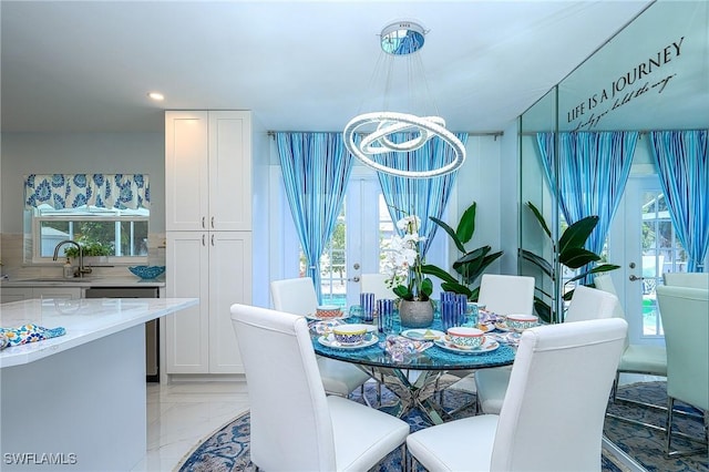 dining room with marble finish floor, french doors, recessed lighting, and an inviting chandelier