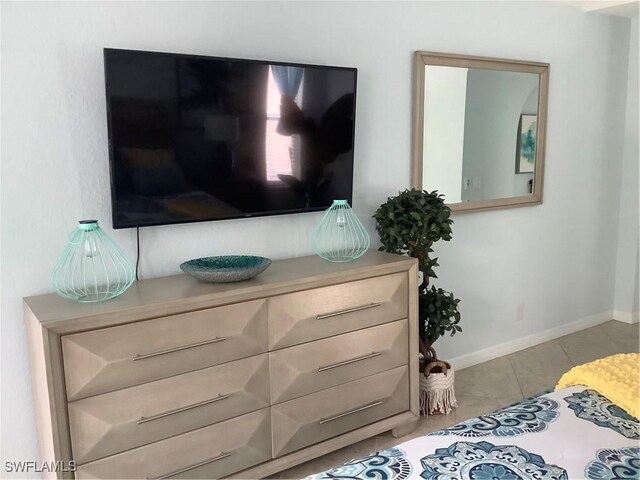 bedroom featuring tile patterned flooring and baseboards