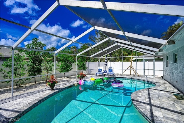 view of pool with a patio, a fenced backyard, a fenced in pool, and a lanai