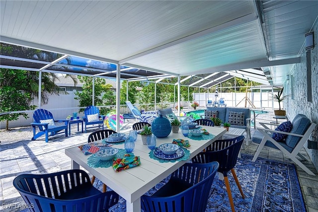 view of patio featuring glass enclosure, a fenced backyard, outdoor lounge area, and a fenced in pool