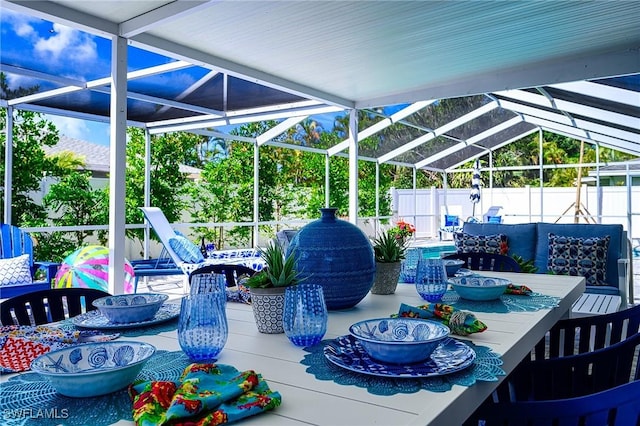 view of patio / terrace featuring glass enclosure, a fenced backyard, and outdoor lounge area