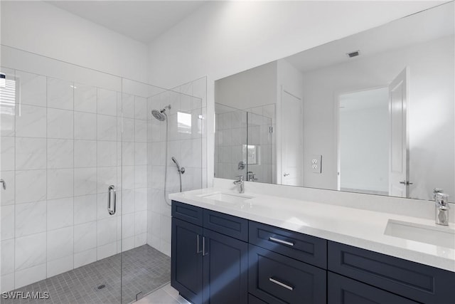 bathroom featuring double vanity, a sink, visible vents, and a shower stall