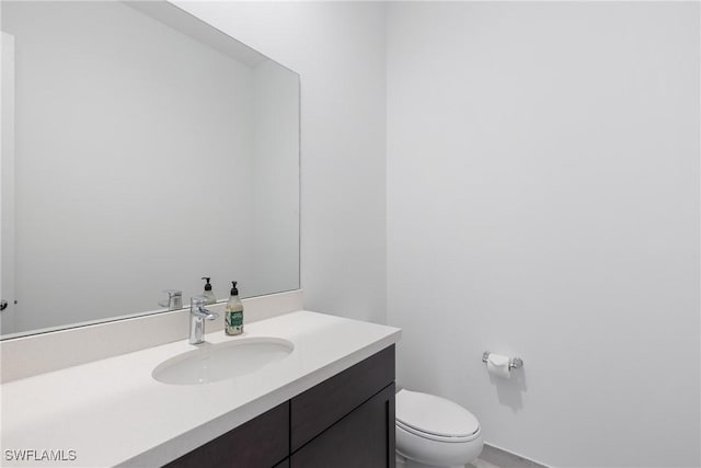 bathroom with vanity and toilet