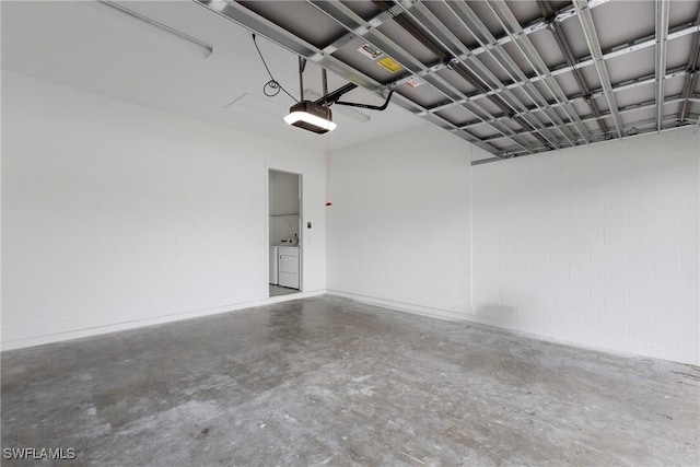 garage with washer and clothes dryer and a garage door opener