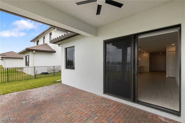 view of patio / terrace with fence and a ceiling fan