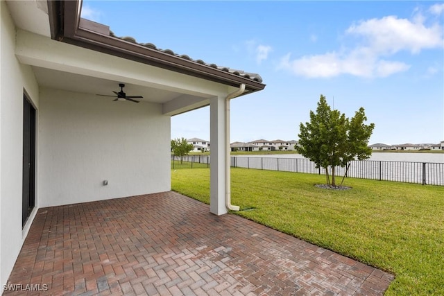 view of patio / terrace with ceiling fan and fence