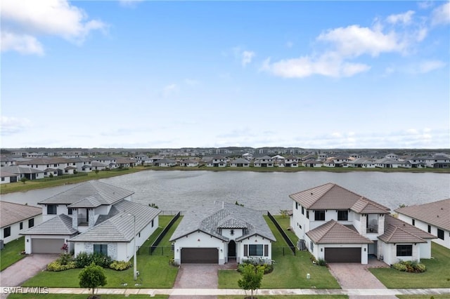 bird's eye view featuring a water view and a residential view