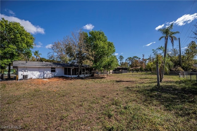 view of yard featuring a sunroom and fence