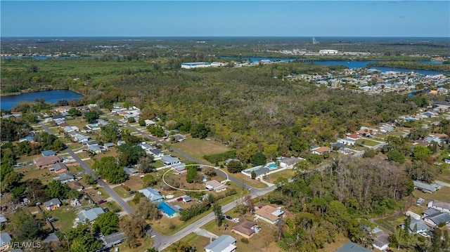 aerial view featuring a water view and a forest view