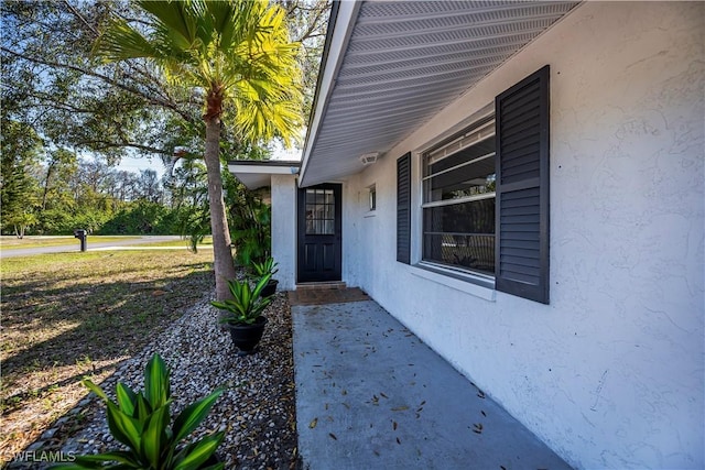 view of exterior entry with stucco siding