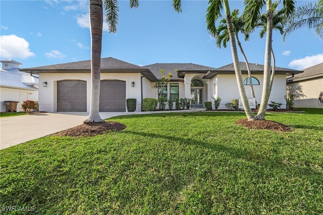 view of front of home featuring a front lawn, french doors, concrete driveway, and stucco siding