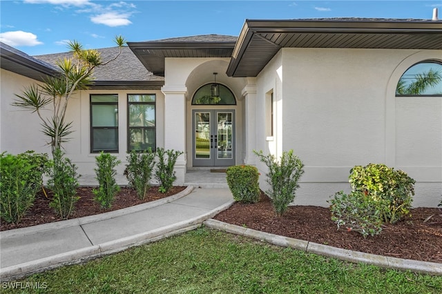 property entrance featuring french doors and stucco siding