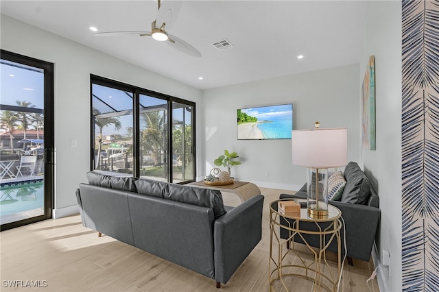 living room with light wood-style floors, recessed lighting, visible vents, and a ceiling fan