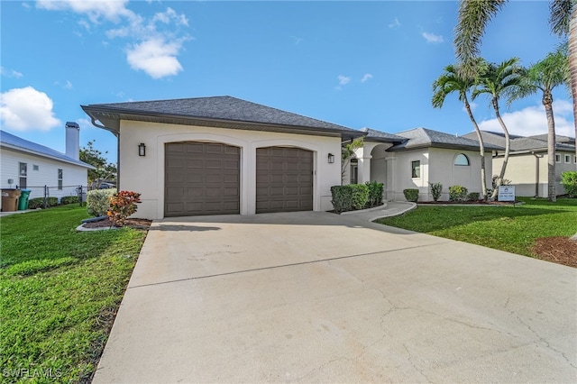 view of front of house with an attached garage, driveway, a front lawn, and stucco siding