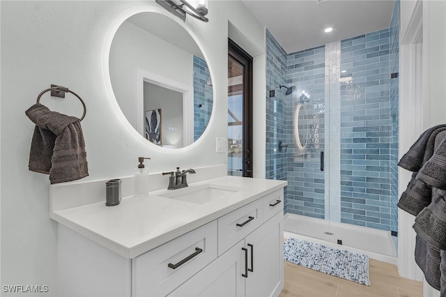 bathroom featuring a shower stall and vanity