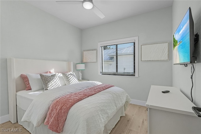 bedroom featuring baseboards, a ceiling fan, and light wood-style floors