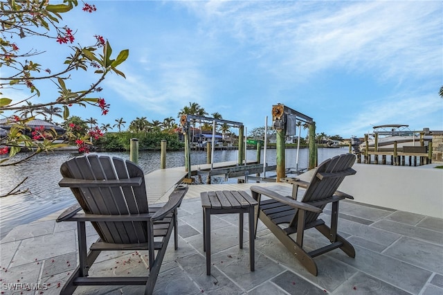 view of patio featuring a dock, a water view, and boat lift