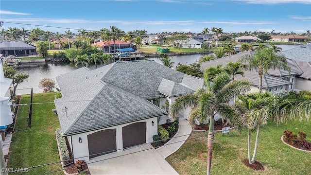 bird's eye view with a water view and a residential view