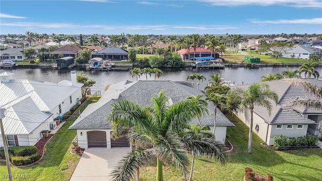 drone / aerial view with a water view and a residential view