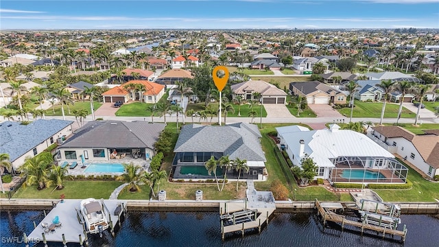 bird's eye view featuring a water view and a residential view