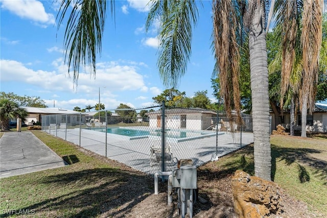 pool featuring a lawn and fence