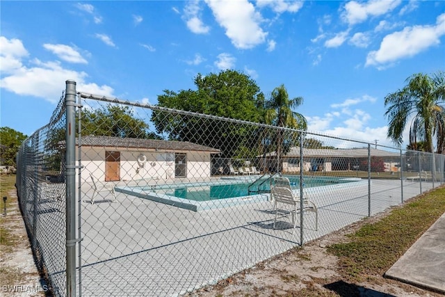 community pool featuring a patio and fence