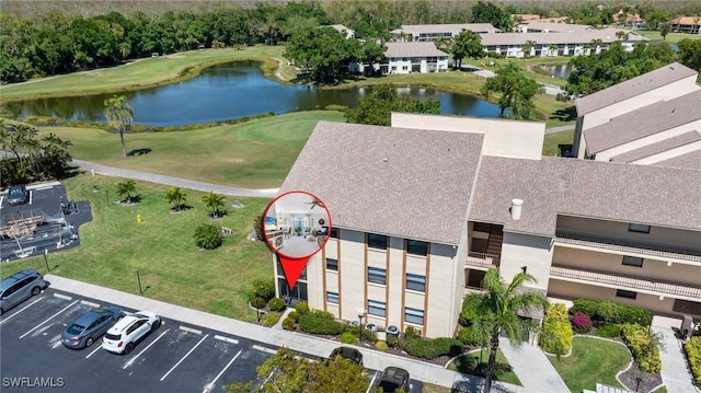 aerial view featuring view of golf course and a water view